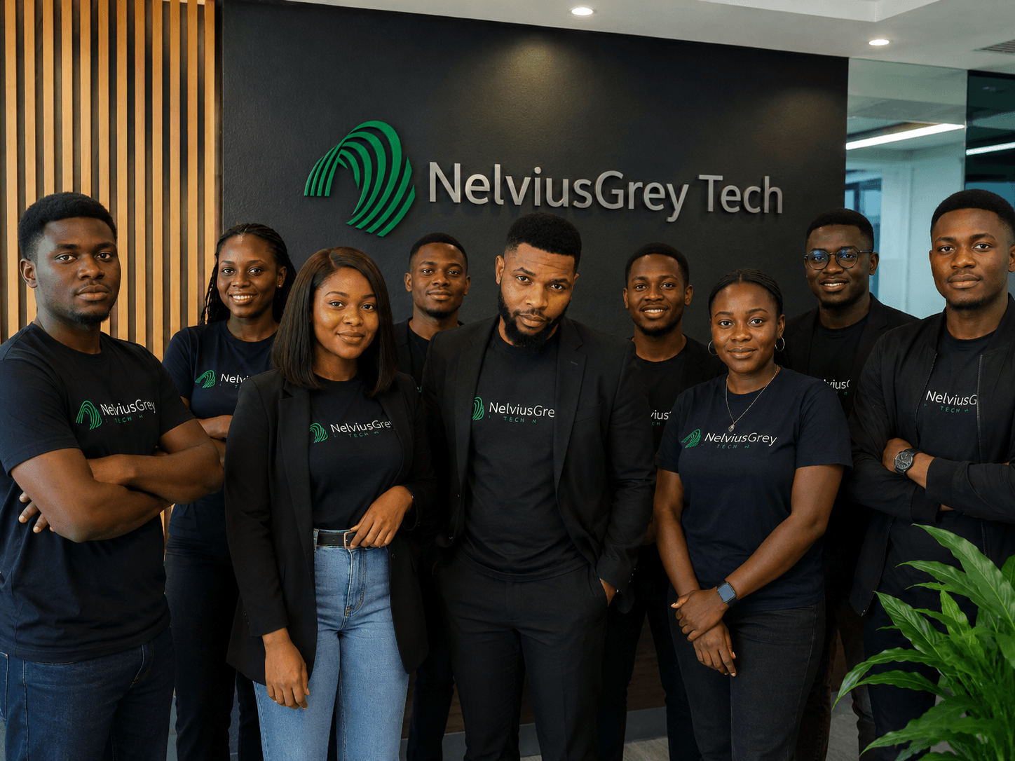 A group portrait in a NelviusGrey Tech-branded Lagos workspace.
